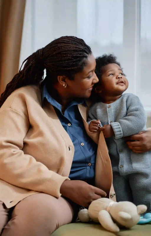 happy-black-woman-in-cardigan-hugging-baby-girl-in-2026-01-09-11-34-17-utc